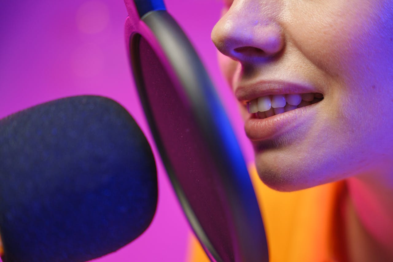 A woman podcasting with a microphone in a vibrant studio setting.